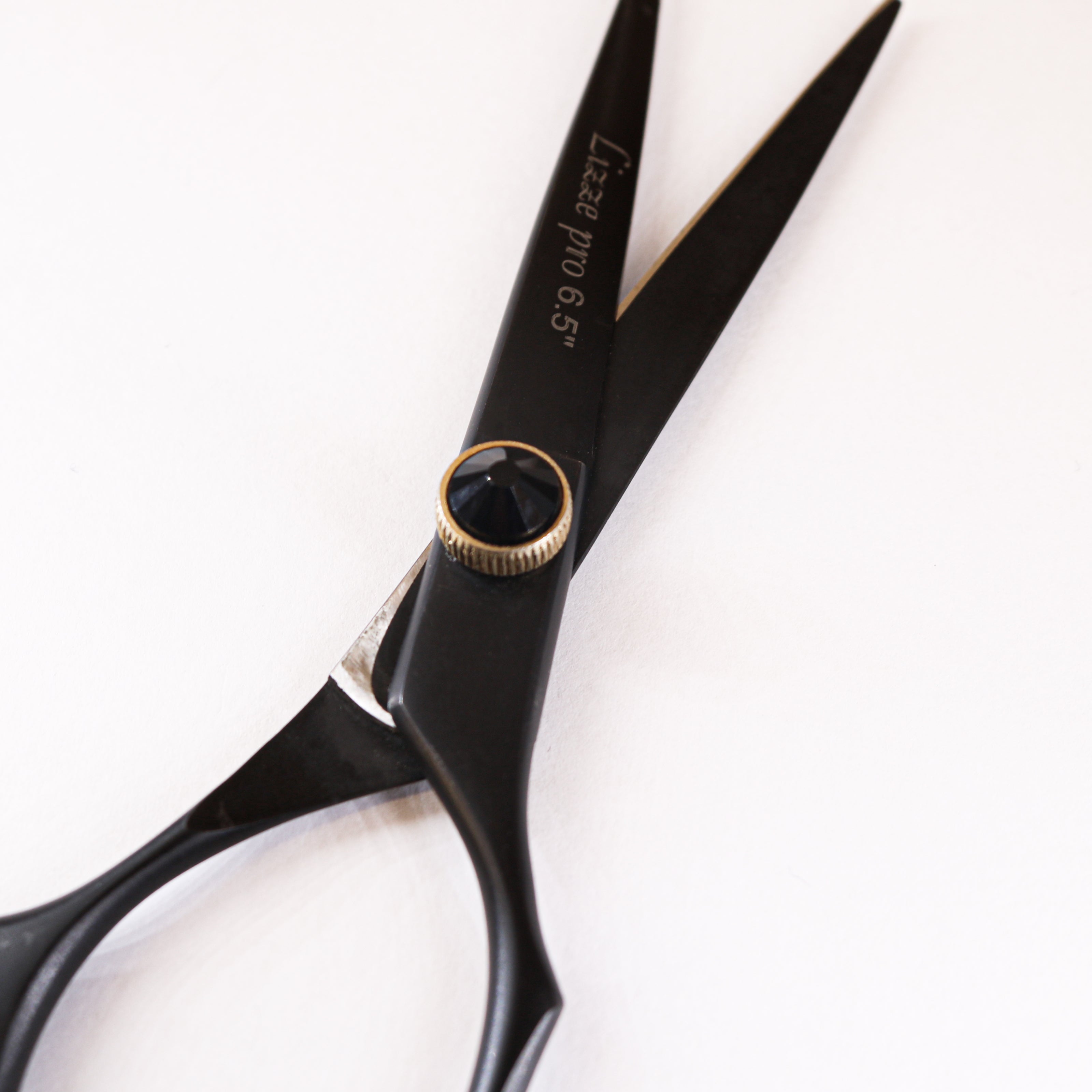 Lizze Pro 6.5-inch black and gold professional hairdressing scissors for precision cutting.